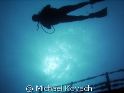 Mika hovering above the Spiegel Grove by Michael Kovach 